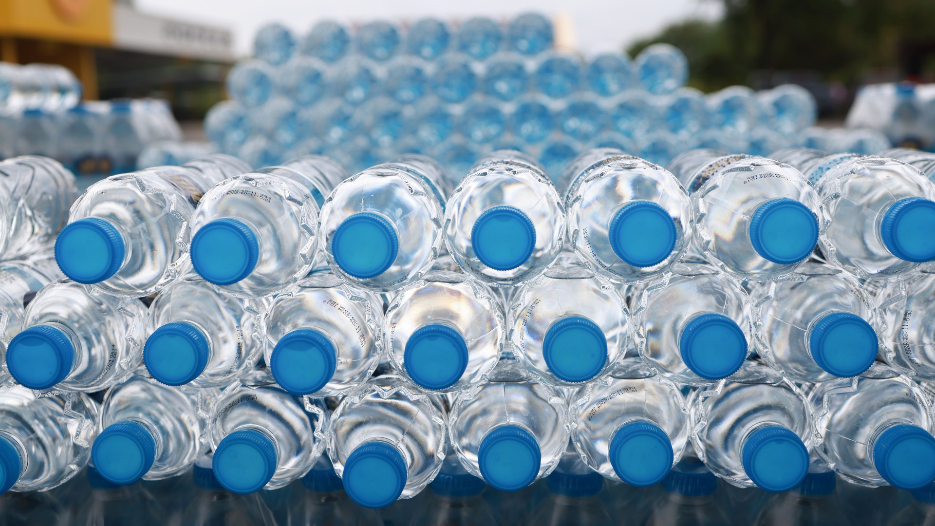 Stack of Drinking Water Bottles. Blue Water Texture with Droplets and Frosty Winter Patterns in the bottom and cover front view